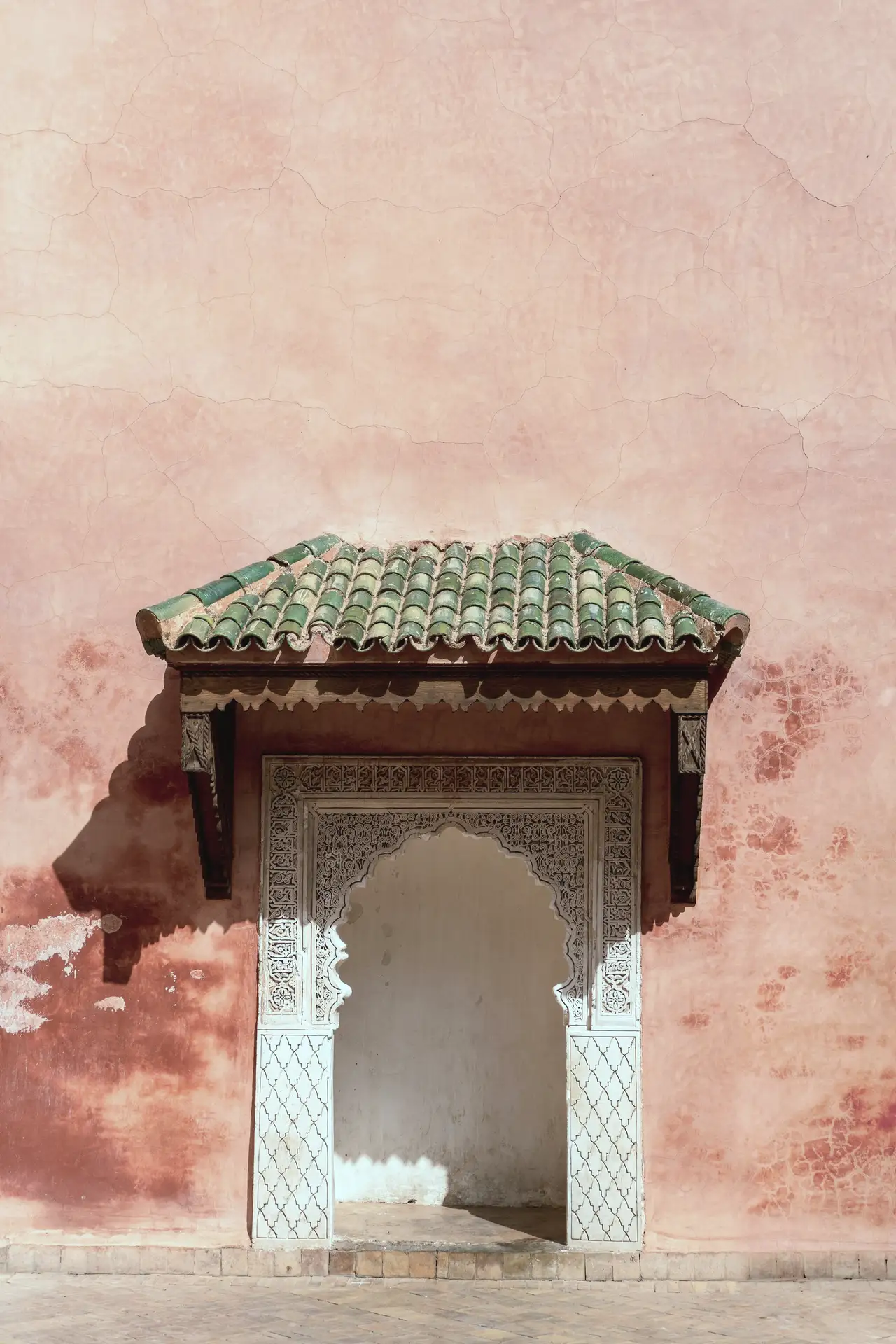 A fountain in a pink wall
