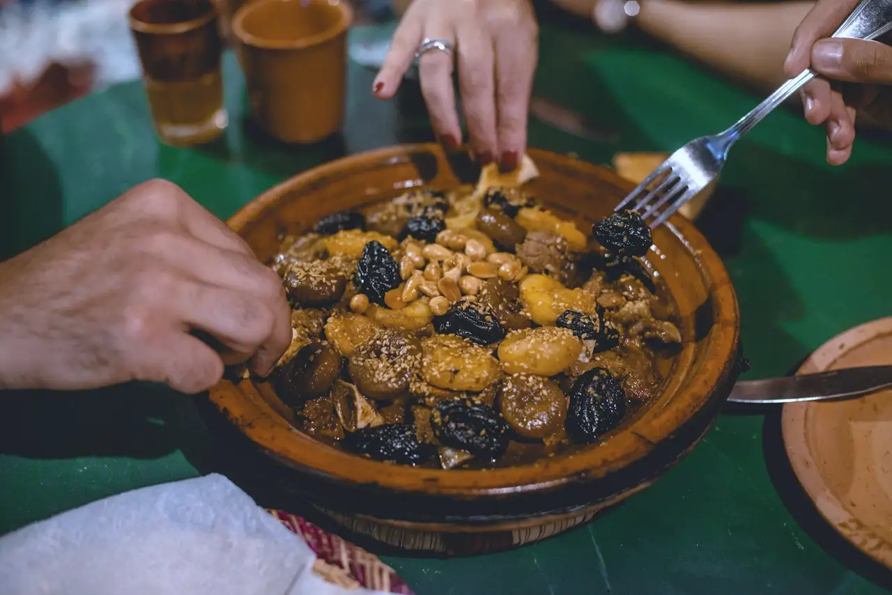 Hands around a shared dish